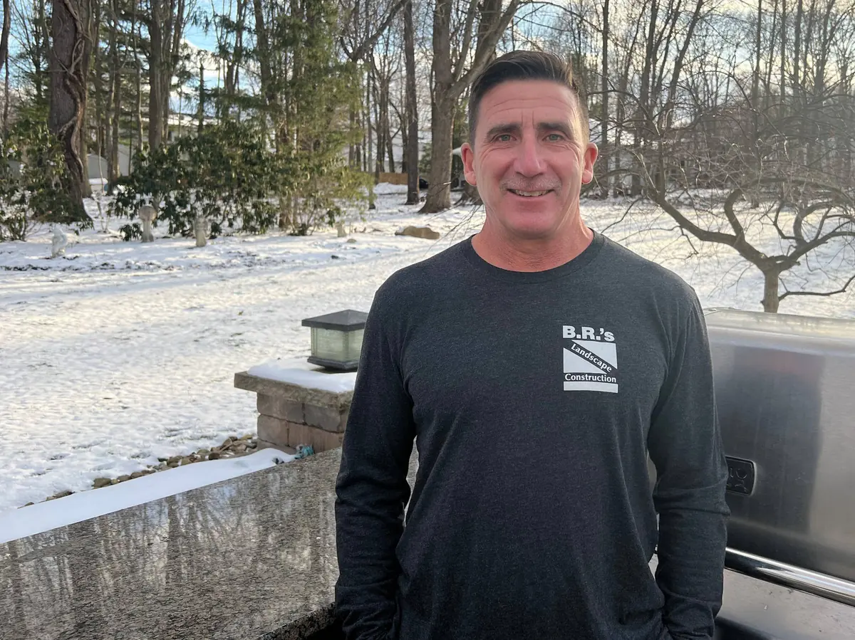 A member of the Reeves family in a B.R.'s Landscape Construction shirt