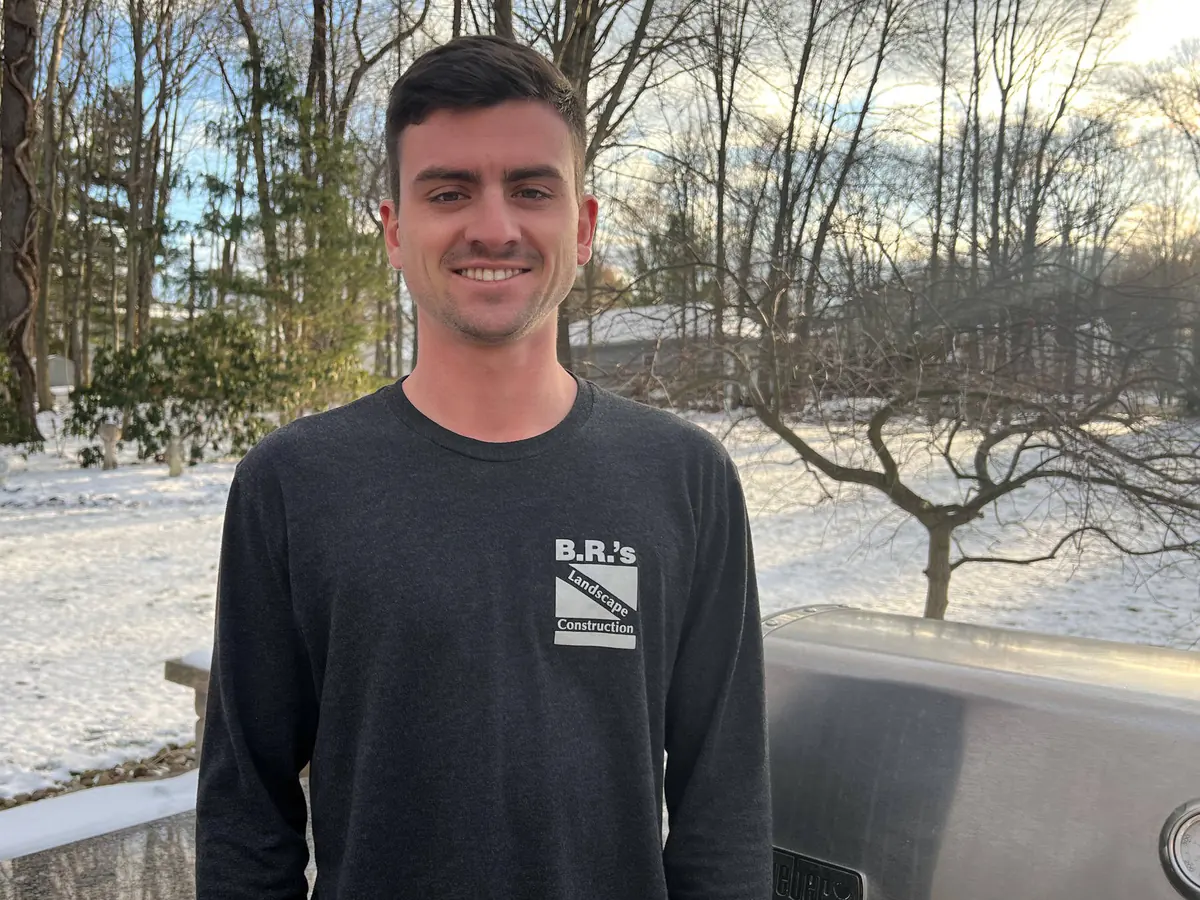 A member of the Reeves family in a B.R.'s Landscape Construction shirt